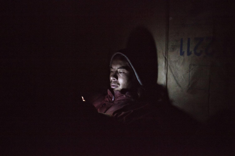 Daniel Etter: Jawad, an illegal immigrant from Afghanistan, texts on his phone in a makeshift hut outside of Subotica, Serbia, Nov. 11, 2012. Jawad came to Europe in 2005 and has been drifting between Greece, Serbia and Hungary unable to find asylum.  Many illegal immigrants try to get from Greece through the Balkans to northern parts of the European Union. Recently, Serbian police deported many refugees from here to Macedonia.